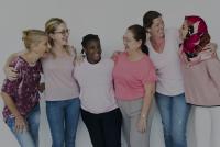 Image: diverse group of women embracing and smiling. Title: Why Investing in  Women Pays Off